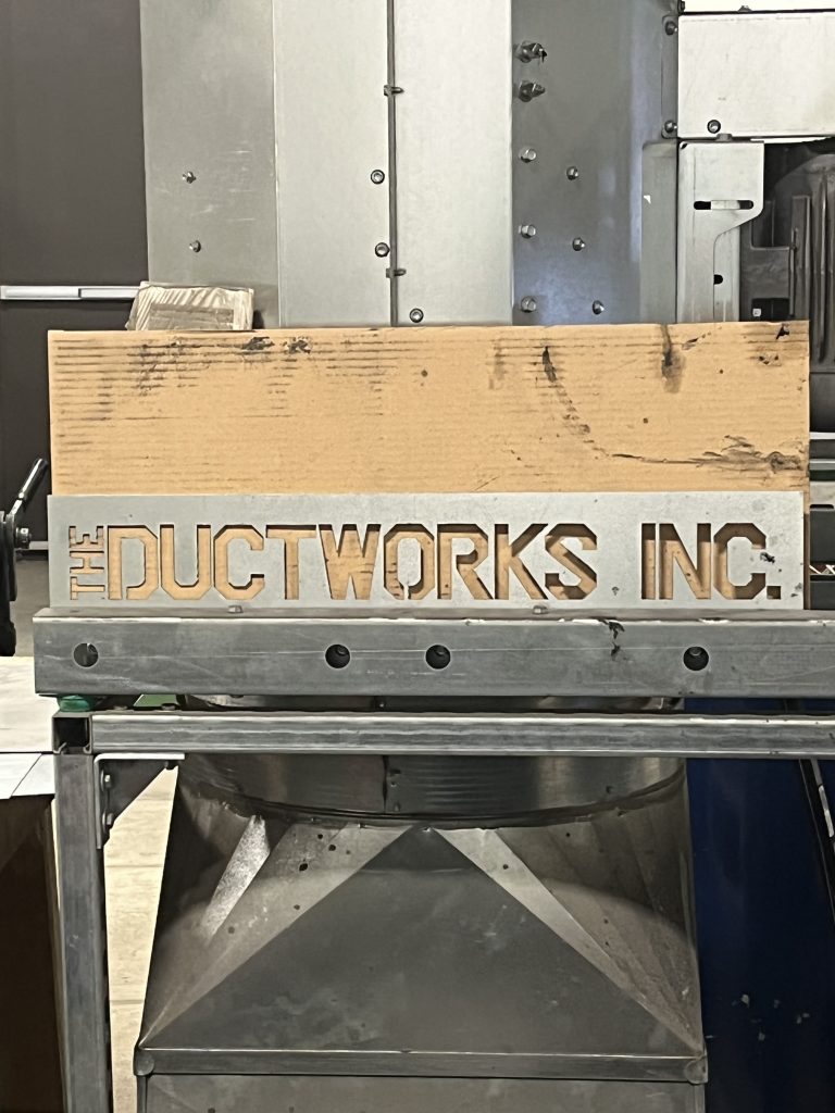 The Ductworks Inc. metal sign on shop equipment